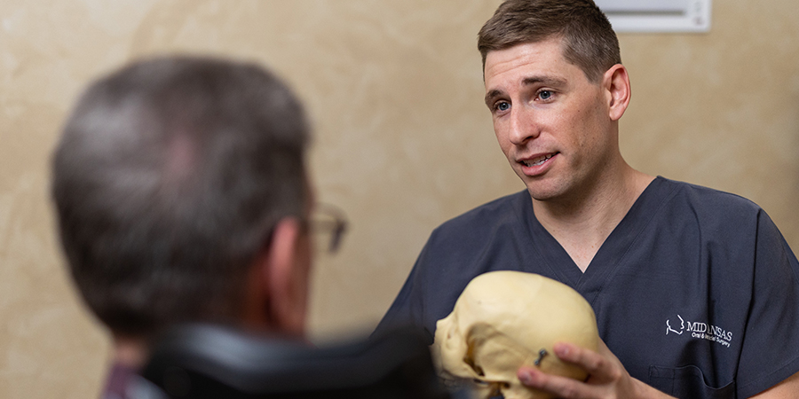 oral surgeon discussing pre-prosthetic surgery with a patient