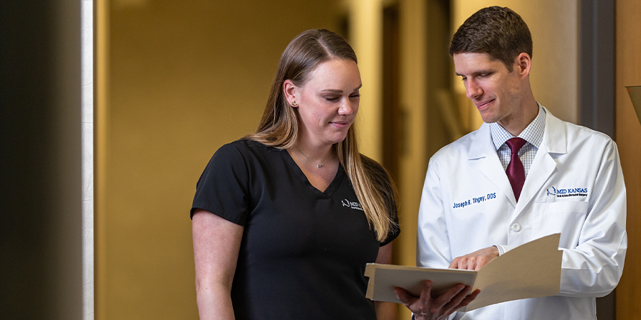 Dr. Tingey looks over paperwork with an assistant